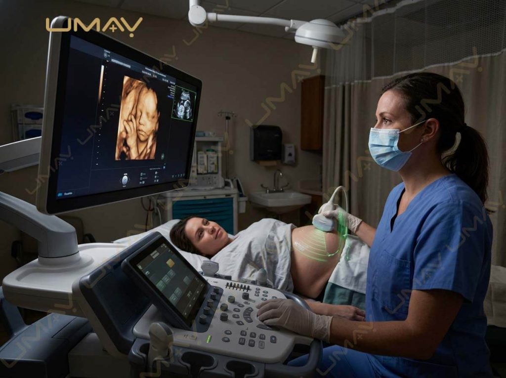 Sonographer using a 4D volume transducer to scan a pregnant patient's abdomen with high-definition fetal imaging on screen.