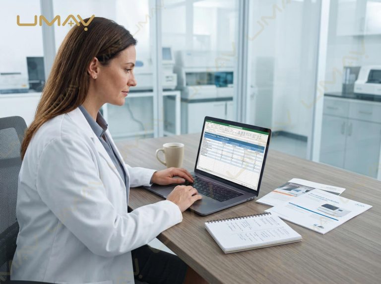 Medical procurement specialist reviewing biochemistry analyzer comparison data on a laptop in an office.