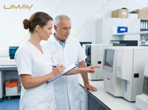 Laboratory staff consulting over automated hematology analyzer selection in a clinical lab.