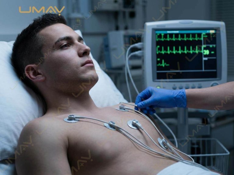 Medical professional placing ECG electrode leads on a male patient's chest in a critical care setting.