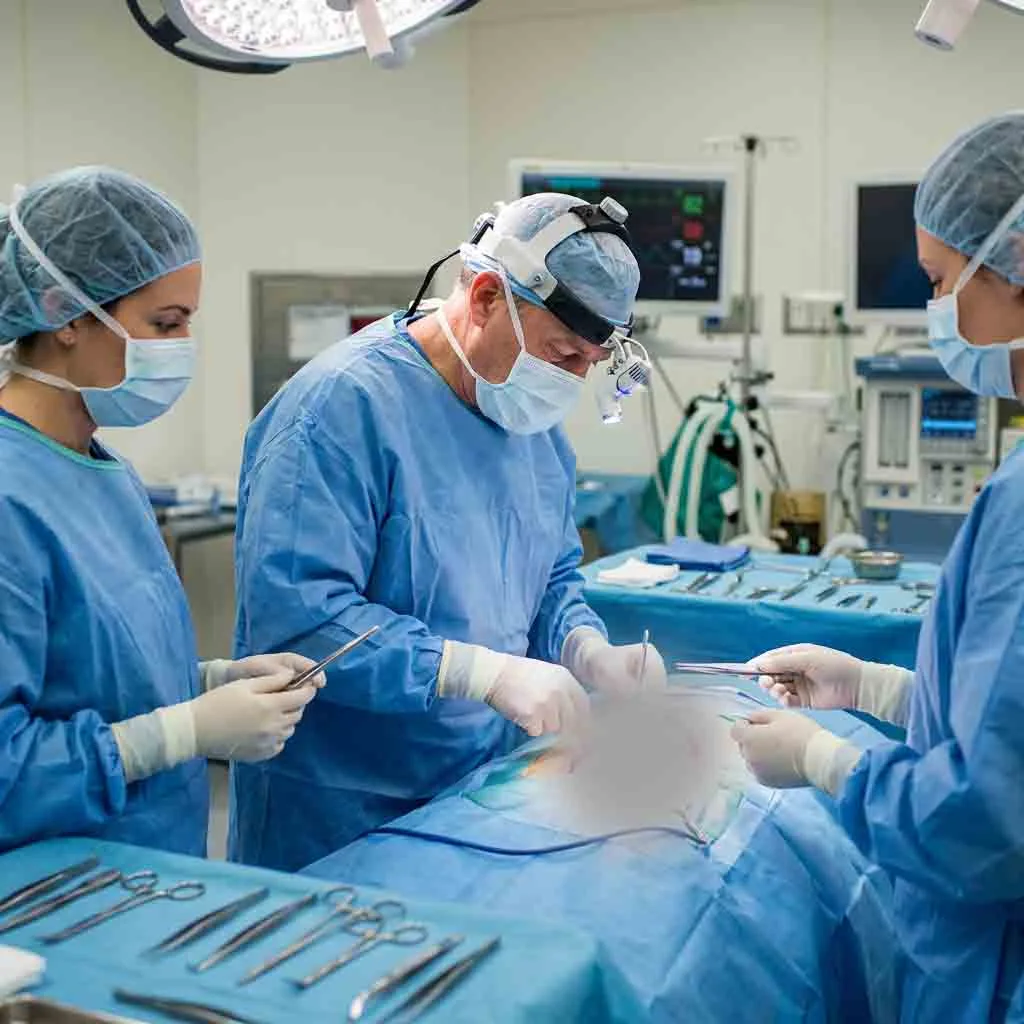Surgical team performing deep cavity procedure using a wearable surgical headlight.